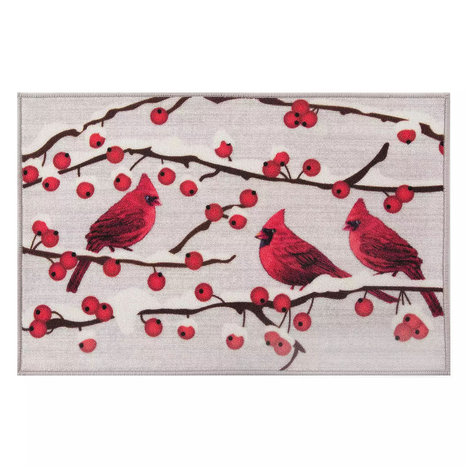 A decorative non-slip rug features red cardinals perched on branches with bright red berries, set against a light background. The rug's playful winter theme complements holiday decor.