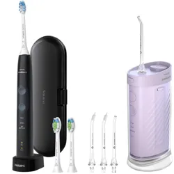Philips Sonicare electric toothbrush with a charging base, travel case, three replacement brush heads, and a water flosser with additional nozzle attachments.