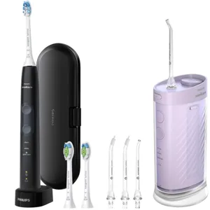 Philips Sonicare electric toothbrush with a charging base, travel case, three replacement brush heads, and a water flosser with additional nozzle attachments.