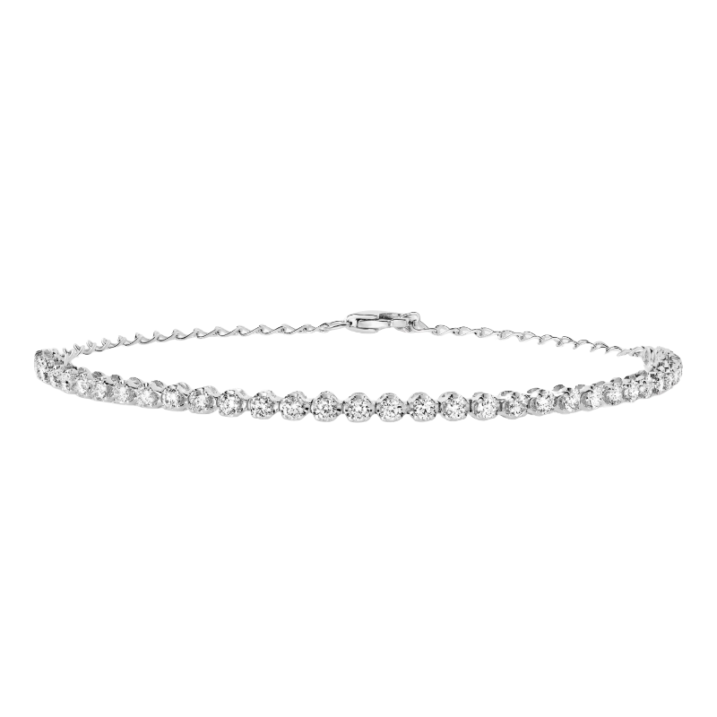 A delicate tennis bracelet featuring a row of sparkling round-cut diamonds set in a thin metal band with a clasp.