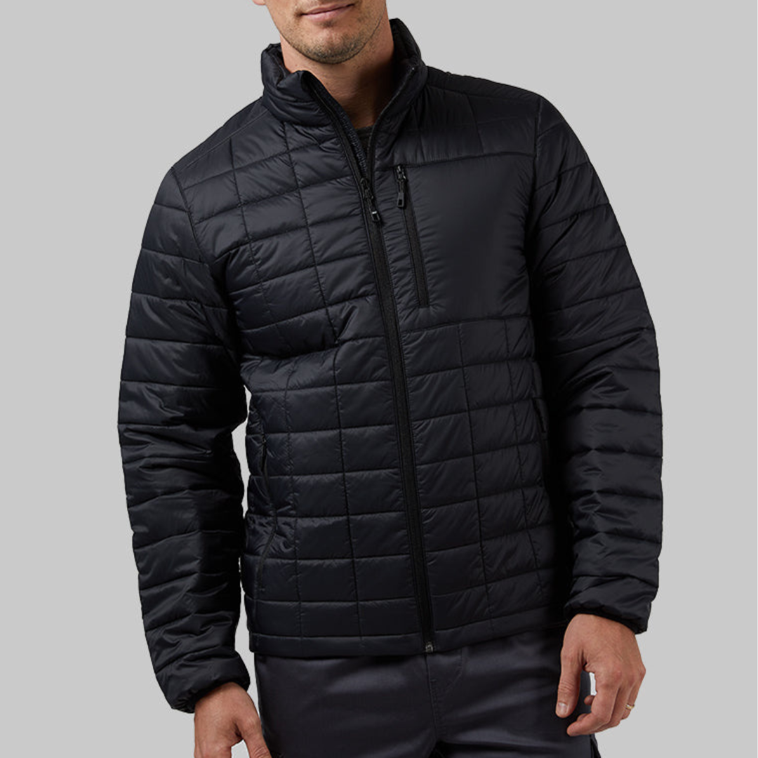 A man is wearing a black quilted jacket with a zippered front and a stand-up collar.