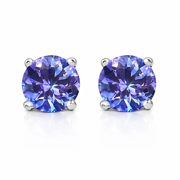 Pair of round-cut, blue-purple gemstone stud earrings set in silver prongs, reflecting light with a vibrant sparkle.