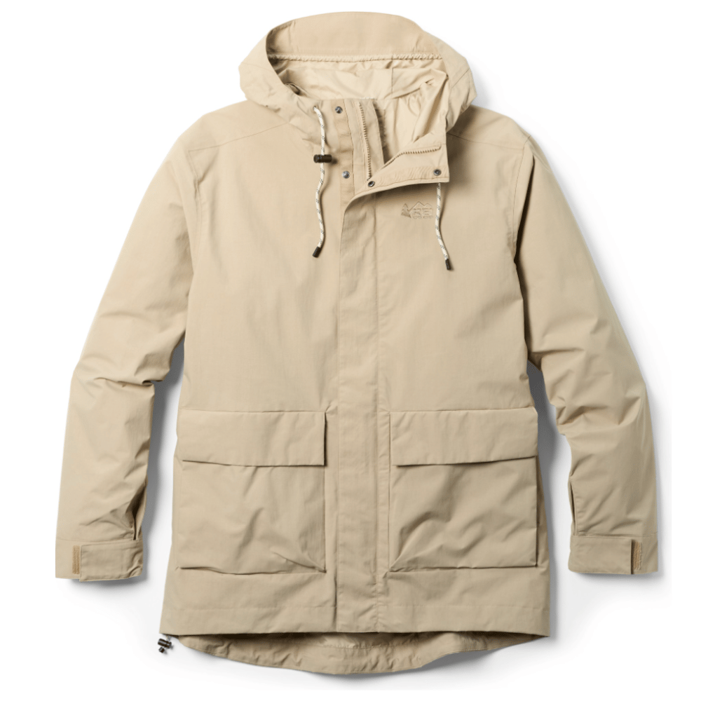 A beige hooded jacket with adjustable drawstrings, large front pockets, and Velcro wrist closures.