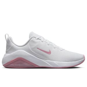 White athletic sneaker with a pink Nike swoosh and pink accents on the sole.