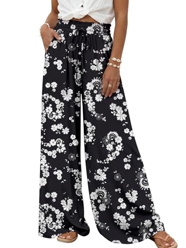Wide-leg black pants with a white floral pattern, featuring an elastic waistband and drawstring, paired with a white sleeveless top.