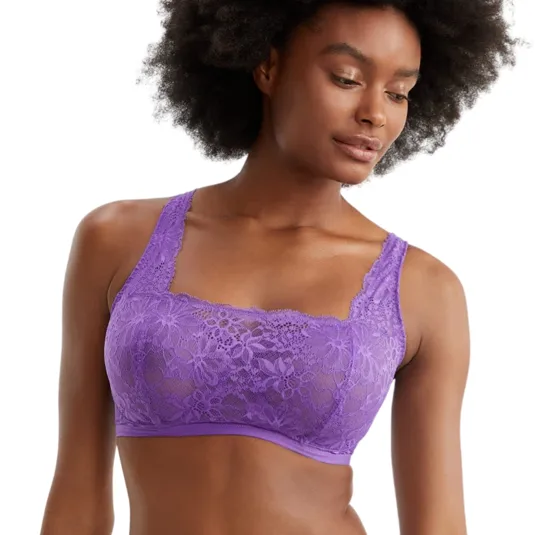 A woman is wearing a matching set of purple lace lingerie, featuring a bralette and briefs, with floral patterns.