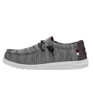 A grey knit fabric shoe with a white sole, featuring lacing details and contrasting patterns near the heel.