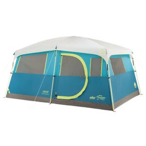 Coleman 8-Person Tent with an instant cabin design features blue and white panels, large mesh windows, and a wide, D-shaped door. Its spacious interior and easy setup make it suitable for family camping trips.