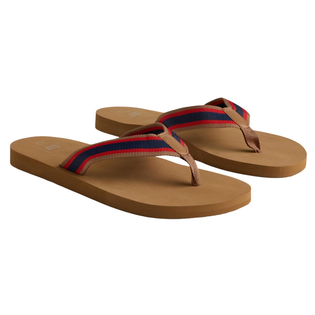 A pair of brown flip-flops featuring red and blue striped fabric straps.