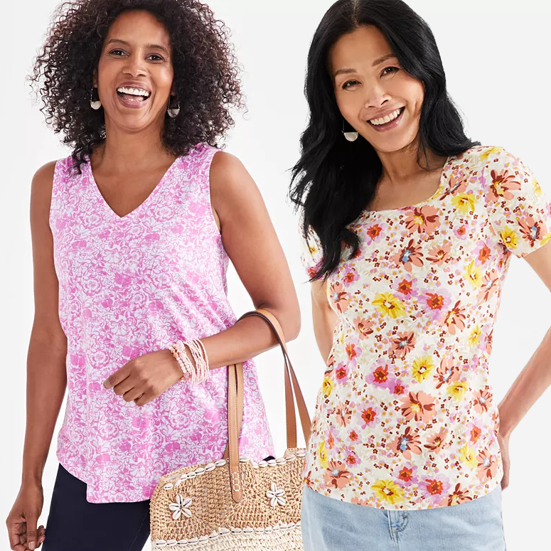 Two women wearing floral print tops; one in pink with a V-neck, the other in a pastel flower design with a scoop neck.