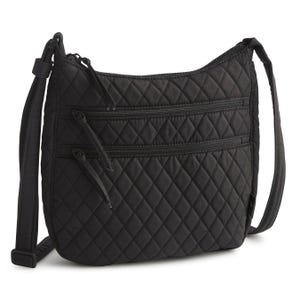 A black quilted crossbody bag with an adjustable strap, featuring two front zippered pockets and a top zipper closure.