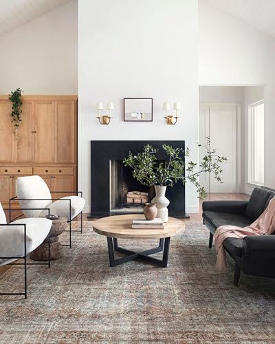 A textured area rug with a blend of muted blue, pink, and beige tones, featuring a distressed pattern that contributes to a vintage aesthetic.