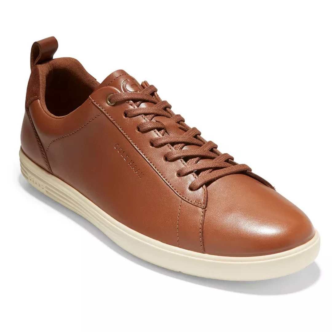 Brown leather sneakers with lace-up closure and a white rubber sole, featuring subtle branding on the side.