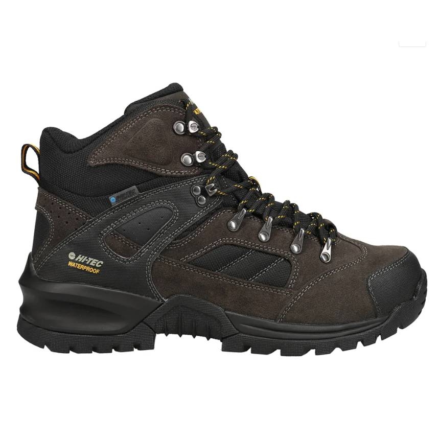 Hi-Tec Waterproof Hiking Boot in dark brown with black mesh inserts, featuring a high-ankle design, durable rubber sole, metal eyelets for laces, and yellow stitching accents.