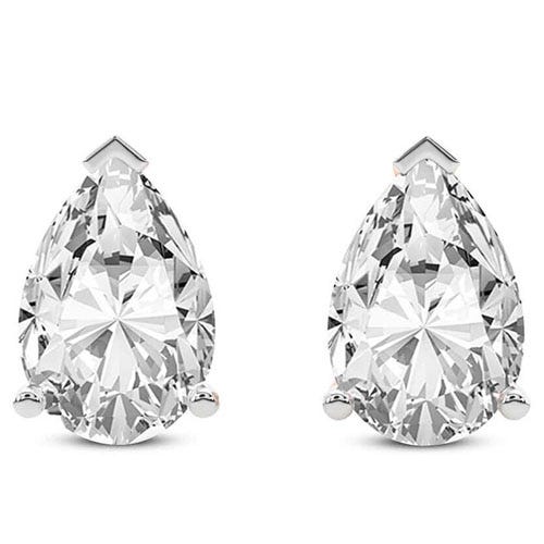A pair of pear-shaped diamond stud earrings set in white metal, each secured with a three-prong setting.