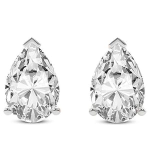 A pair of pear-shaped diamond stud earrings set in white metal, each secured with a three-prong setting.
