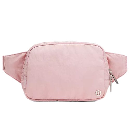 Pink belt bag with a zip closure and the Lululemon logo on the lower right corner.