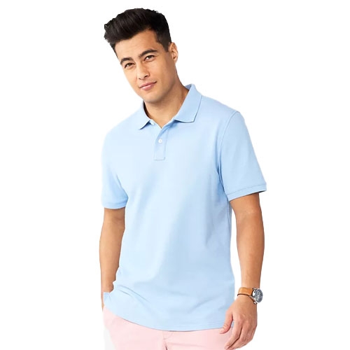 A man wears a light blue polo shirt and pink pants, accessorized with a watch.