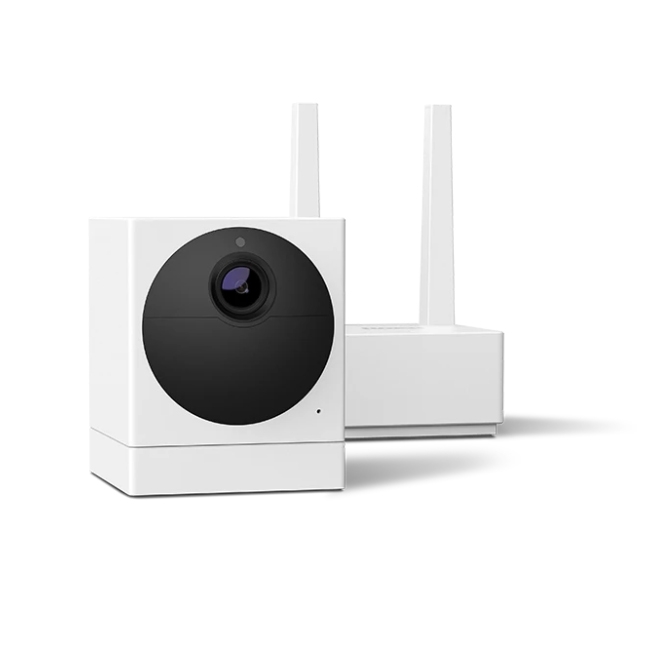 A white, cube-shaped security camera paired with a base station featuring dual antennas, often bundled with a subscription for enhanced features.