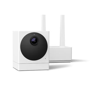 A white, cube-shaped security camera paired with a base station featuring dual antennas, often bundled with a subscription for enhanced features.