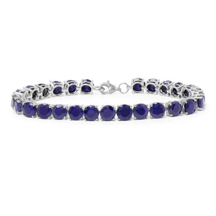 A silver tennis bracelet featuring deep blue gemstones, arranged in a line with a clasp for fastening.