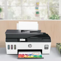 HP multifunction ink tank printer with an automatic document feeder, displaying a vibrant color printout.