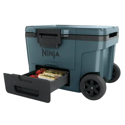 A wheeled cooler with a pull-out storage drawer containing food items, labeled \“Ninja.\“