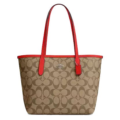 The Coach Outlet Small City Tote features a brown signature jacquard pattern with red handles and trim, and a Coach logo on the front. The tote has a classic open-top design with a zipper pouch, ideal for daily use.