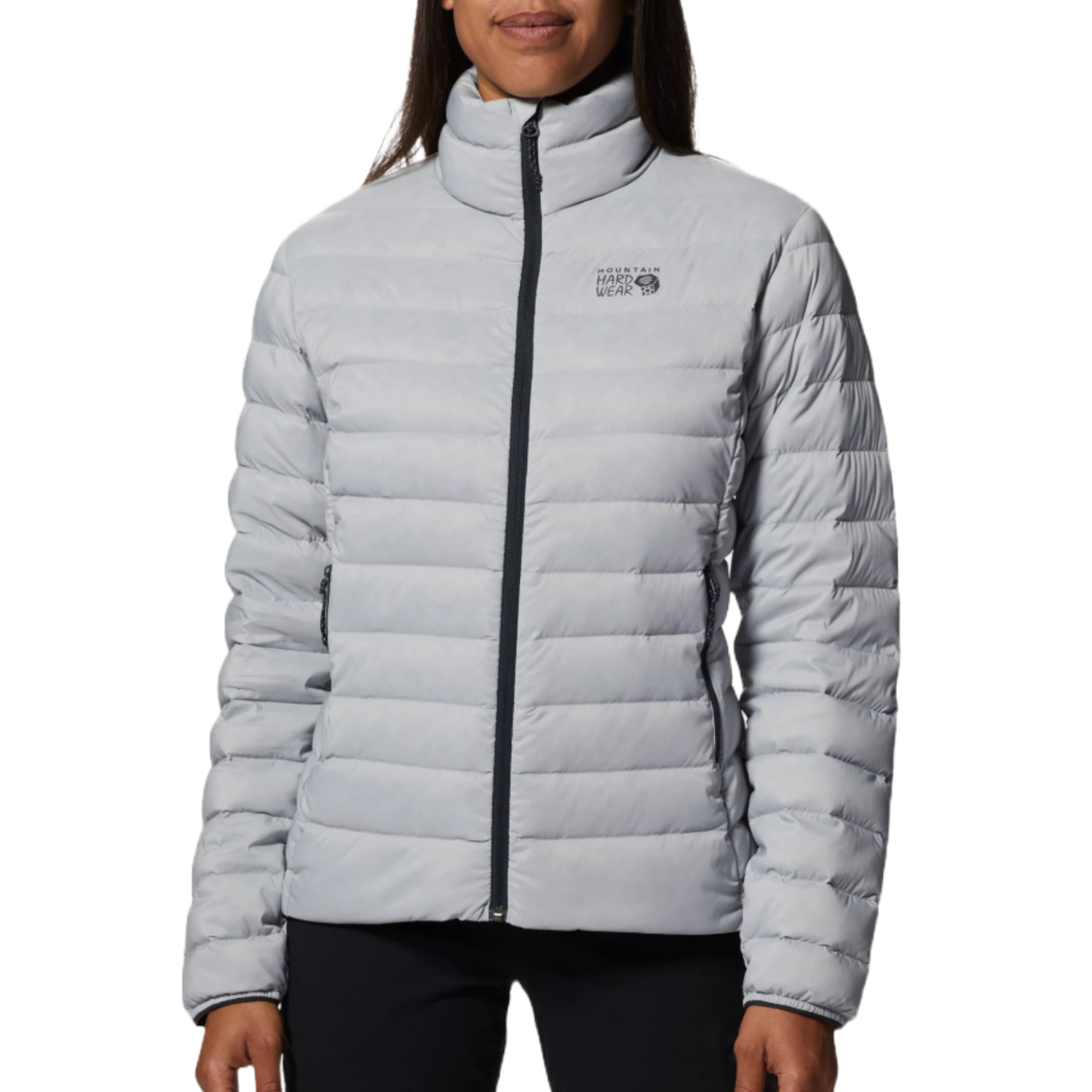 Mountain Hardwear Deloro Jacket is a light gray, insulated jacket with a full zip front and logo on the upper left chest. It features a quilted design for warmth and side pockets for convenience.