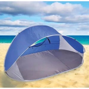Blue and gray pop-up beach tent on sand, featuring an open front design for shade and ventilation. Ideal for beach outings.