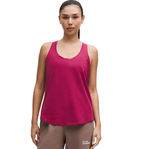 Lululemon Love Tank features a relaxed, sleeveless design with a scoop neck and is shown in a vibrant pink color. It's paired with brown joggers displaying the \“EST. 1998 LULULEMON\“ print.