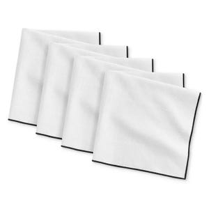 White cloth napkins with black trim, arranged slightly overlapping each other.