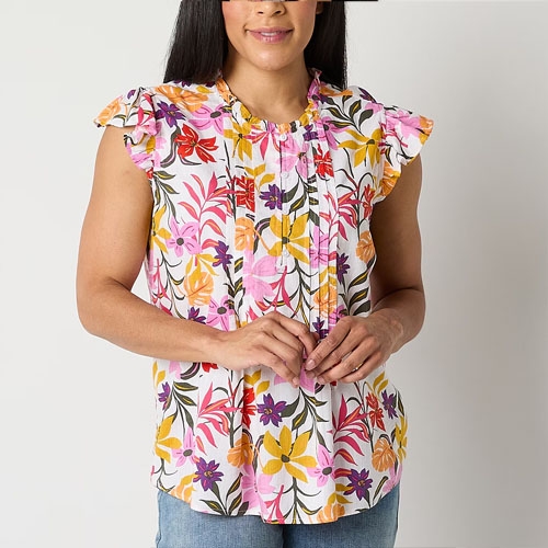 A woman is wearing a floral print sleeveless blouse with ruffle details at the shoulders.