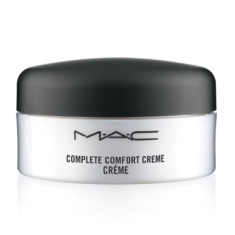 MAC Complete Comfort Crème is a moisturizer designed to soothe and hydrate the skin, presented in a cylindrical white container with a black lid.