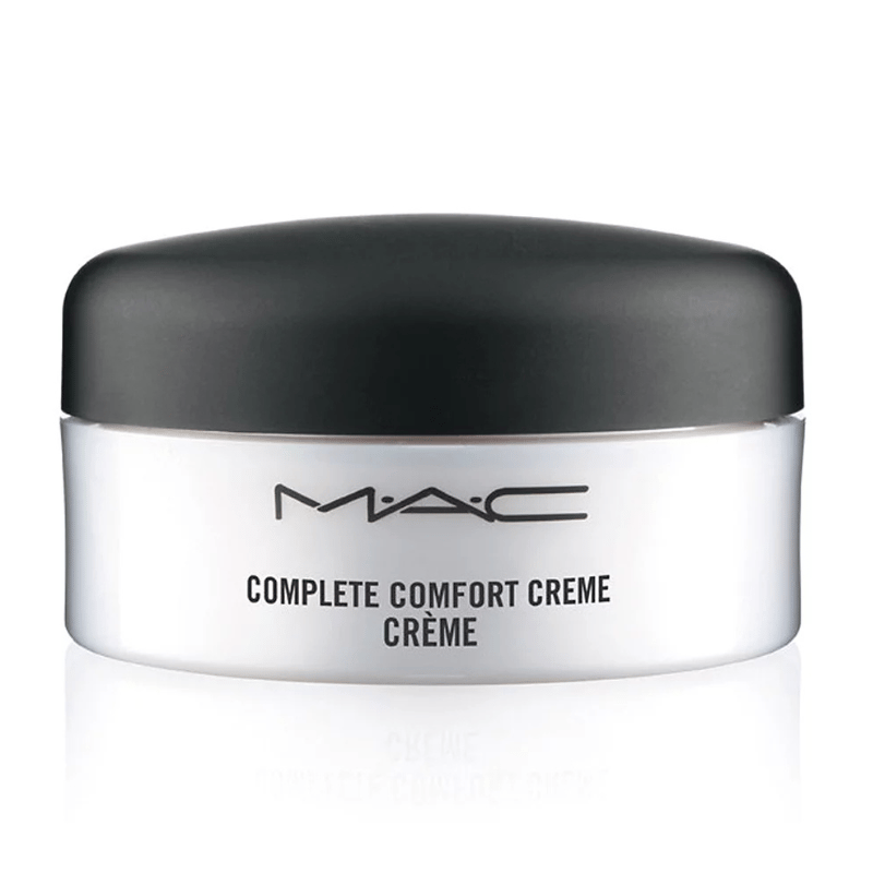 MAC Complete Comfort Crème is a moisturizer designed to soothe and hydrate the skin, presented in a cylindrical white container with a black lid.