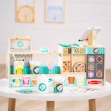 A colorful wooden coffee shop playset with pretend coffee cups, pastries, a cash register, and other cafe accessories, designed for imaginative play and role-playing as a barista.