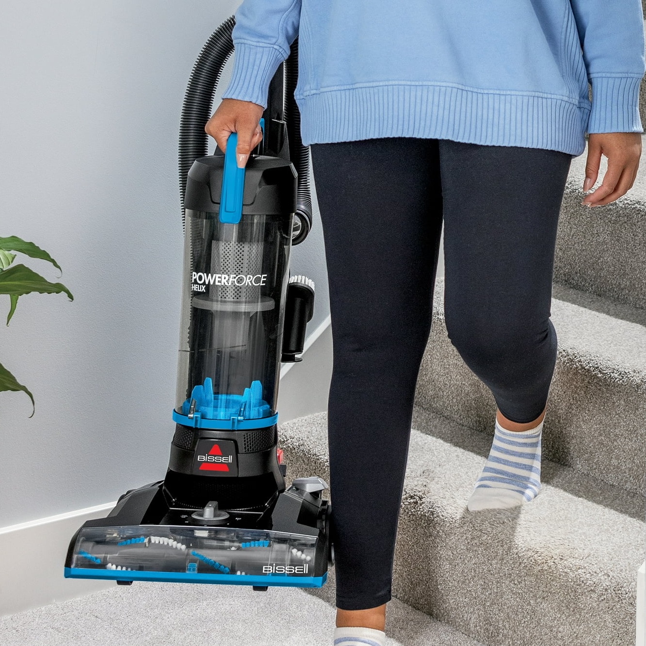 A Bissell PowerForce Helix vacuum cleaner being used on stairs.