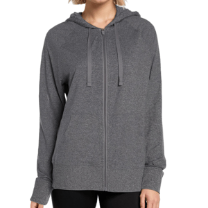 A woman is wearing a gray zip-up hoodie with a hood, long sleeves, and what seems to be a soft, textured fabric.