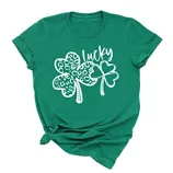 Green t-shirt with a design featuring two shamrocks, one patterned with leopard spots and the word \“lucky\“ in a playful script above them.