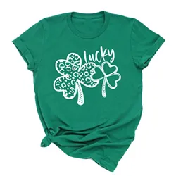 Green t-shirt with a design featuring two shamrocks, one patterned with leopard spots and the word \“lucky\“ in a playful script above them.
