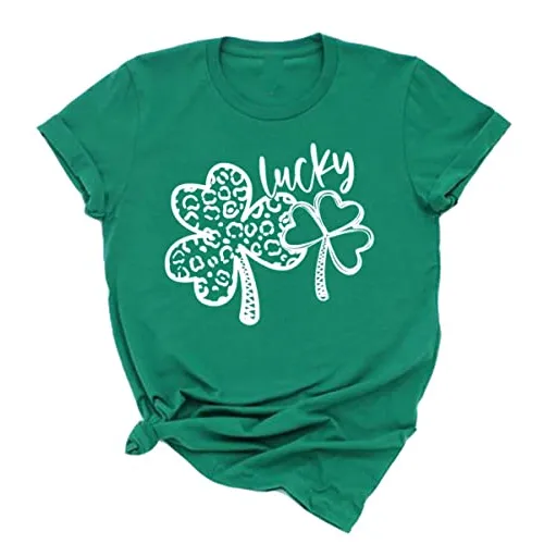 Green t-shirt with a design featuring two shamrocks, one patterned with leopard spots and the word \“lucky\“ in a playful script above them.