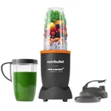 A NutriBullet blender, branded with McLaren Formula 1, containing fruits and vegetables, is shown alongside a green smoothie in a handled cup and additional lids.