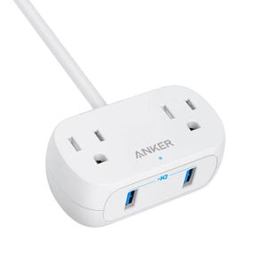 A white Anker power strip with two standard AC outlets and two USB ports, featuring a blue LED indicator and a white cable.