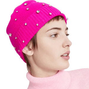 A bright pink beanie adorned with scattered rhinestones, paired with a light pink turtleneck sweater.