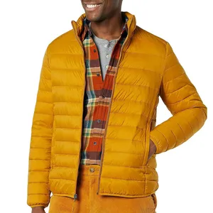 Yellow puffer jacket paired with a plaid shirt and mustard corduroy pants.