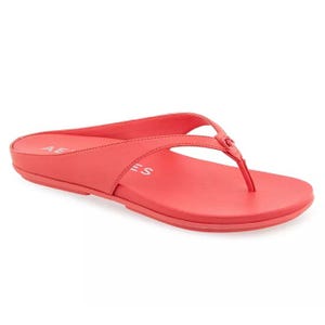 Red flip-flop sandal with a simple design, featuring a toe post and minimalistic straps.