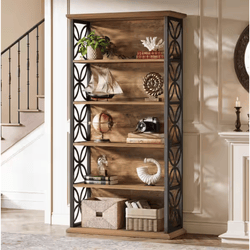 A wooden bookshelf with black decorative side panels features various items like a potted plant, model ship, globe, camera, and decorative sculptures. It also includes storage baskets on the bottom shelf.