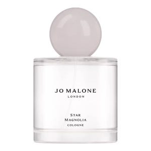 Jo Malone London Star Magnolia Cologne features a minimalist design with a round cap and clear bottle. The label displays the brand name and fragrance type, emphasizing its elegance and simplicity.