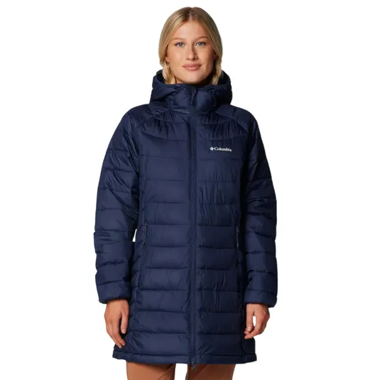 A woman is wearing a navy blue hooded puffer coat from Columbia, featuring a mid-length design and front zipper closure.