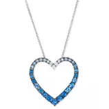 A heart-shaped necklace with a gradient of blue gemstones set in a silver chain.